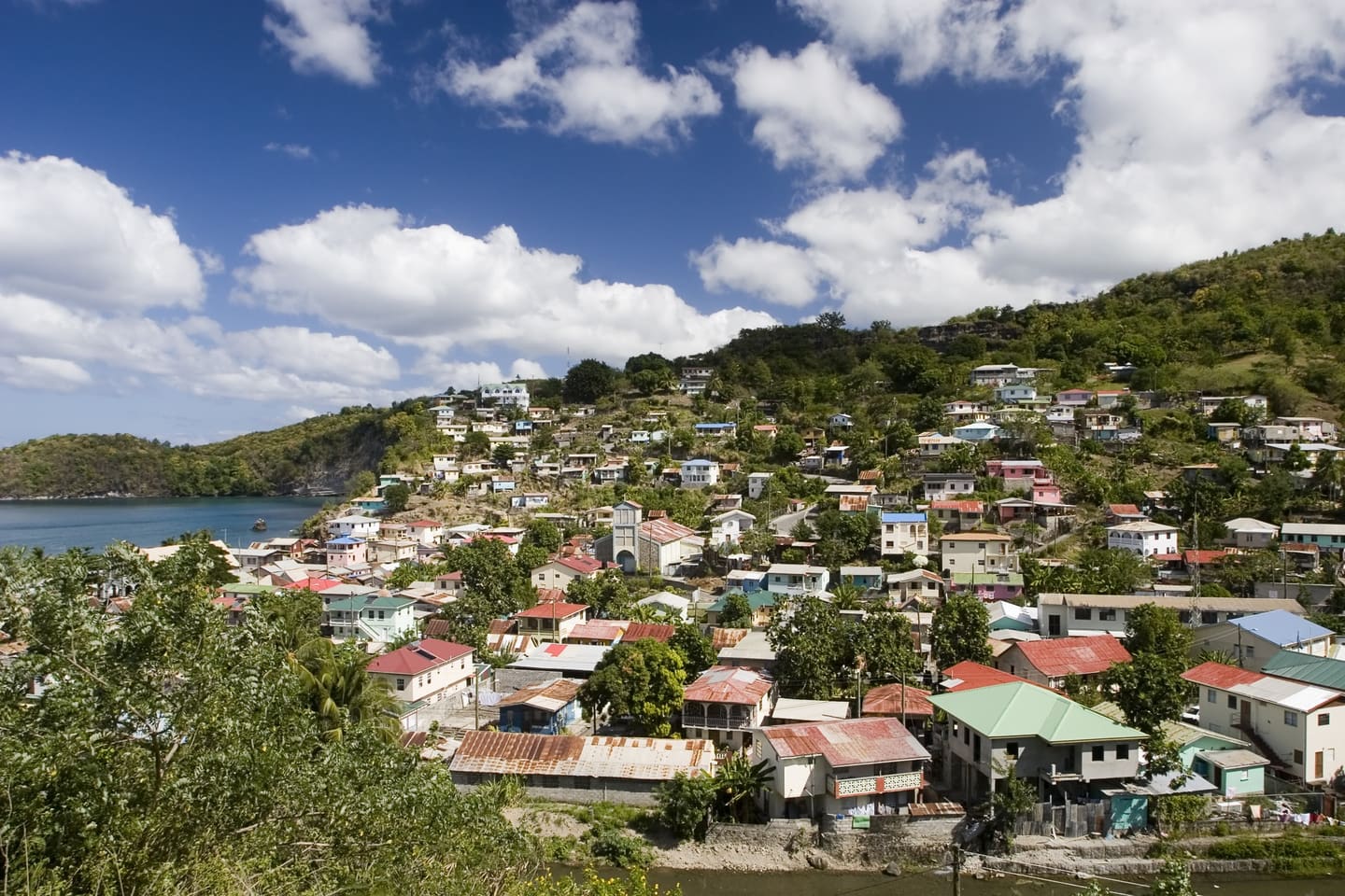 A coastal village on a hillside above a bay in Saint Lucia